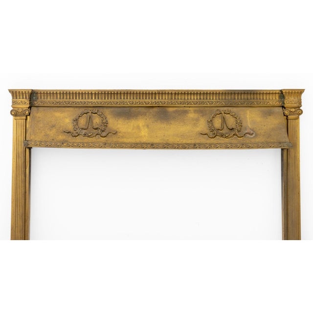 American Gilded Age Brass Fireplace Surround, circa 1900, with wreath and bow motif between two ionic columns. 31.5" H x...