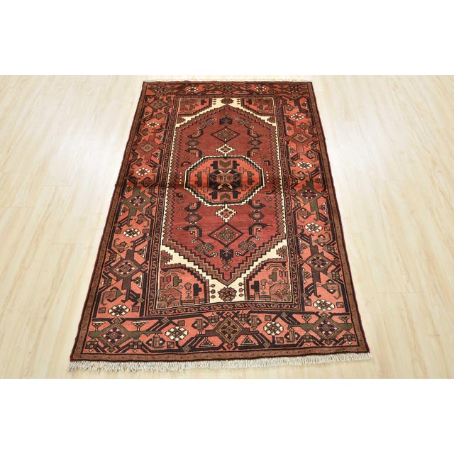 An authentic vintage tribal Hamedan rug hand-knotted with fine wool and natural dyes. This nomadic oriental rug features a...