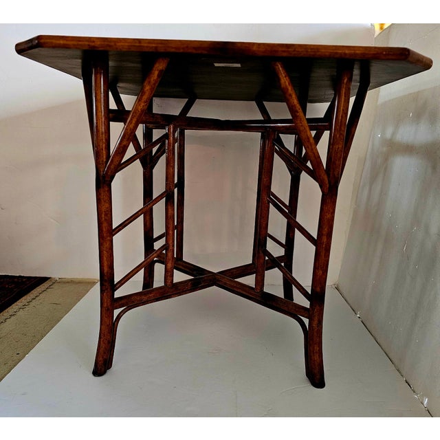 Lovely chinoiserie style lacquered game table having honey colored bamboo base. Top is beautifully decorative with black...
