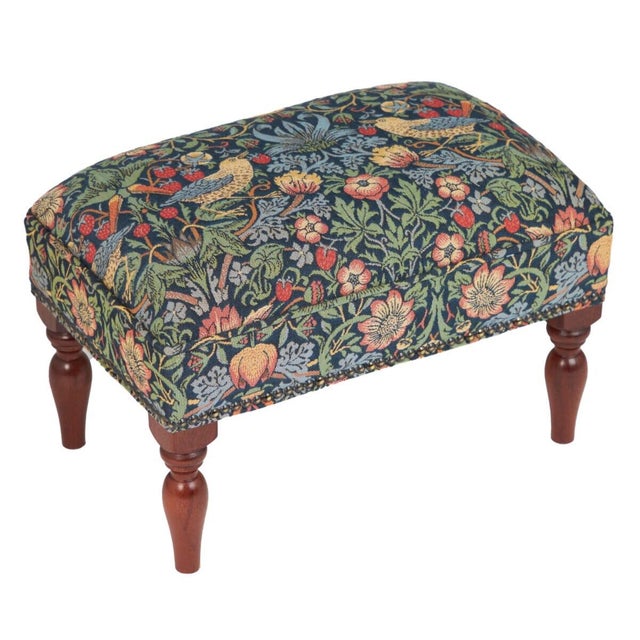 Meticulously handcrafted in the United Kingdom, this upholstered stool boasts classic studding and hand-polished solid...