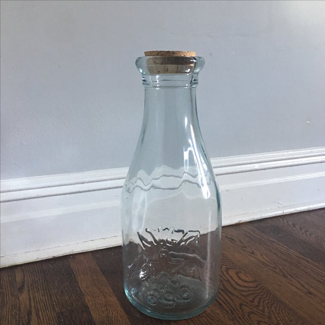 Star milk bottle with cork. Has an image of a cow on one side and "milk, 1890" and a star. Perfect condition. 18"in height.