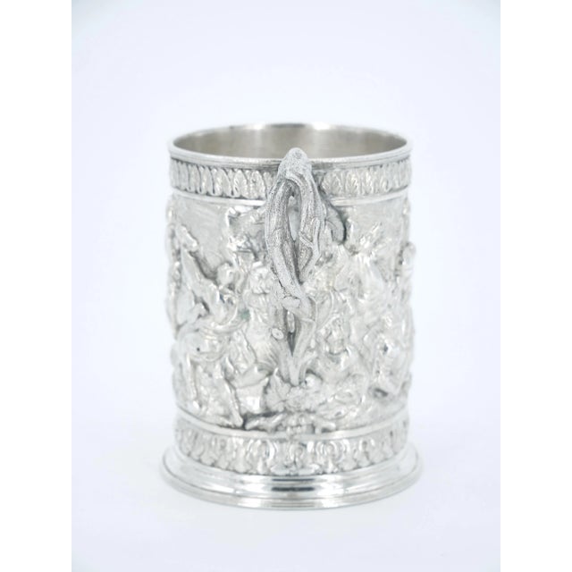Nineteenth century Victorian period English silverplate mug with exceptional repousse designs in high relief, including...