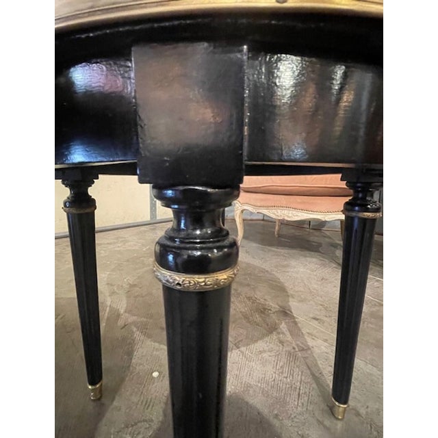 This product is a pair of French Jansen black lacquer side tables in the Louis XVI style. These elegant tables are...