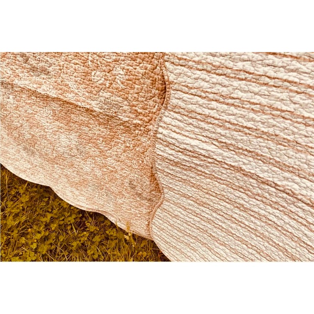 The quilt you wash once and keep for twenty years... A French cotton quilt in a warm caramel ground with a large-scale...