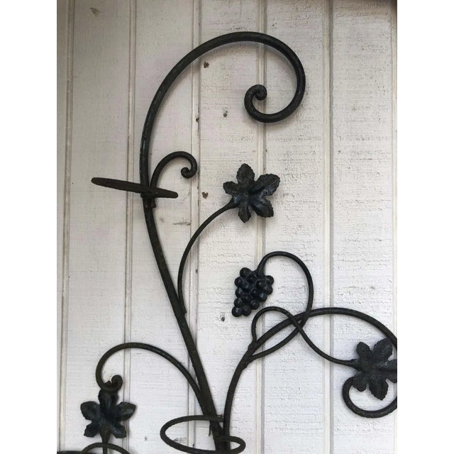 Wrought iron floral garden wall decor. Whimsical with leaves and grapes for three potted plants. 4 inch diameter opening....