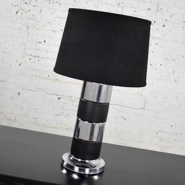 Handsome Art Deco style cylindrical table lamp with black and chrome horizontal stripes and a black drum shade. This lamp...