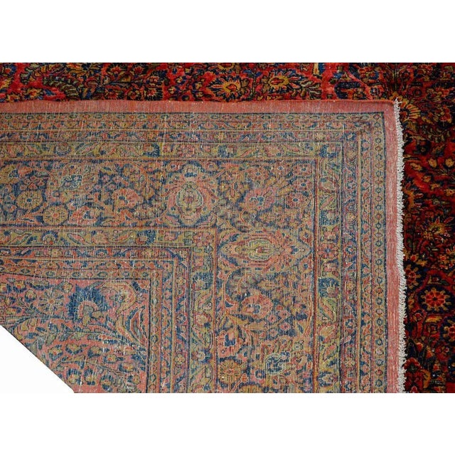 An extraordinary early 20th century Sarouk rug with an elaborate all-over pattern containing myriad flowers woven in...