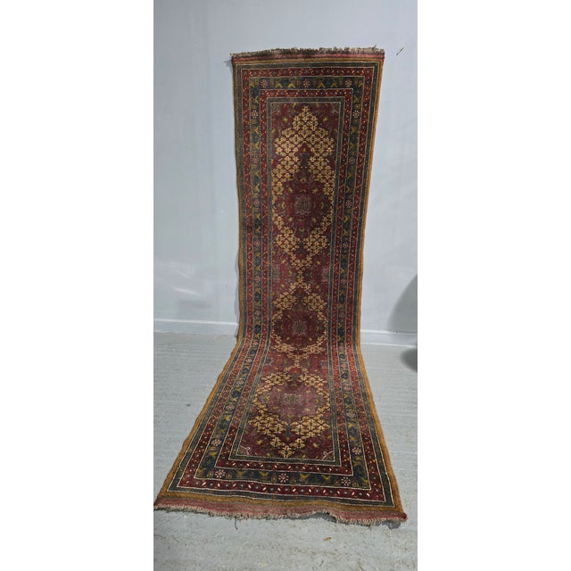 A very good tribal runner, deep red, blue and gold wool, in very good overall condition. 129" x 34"
