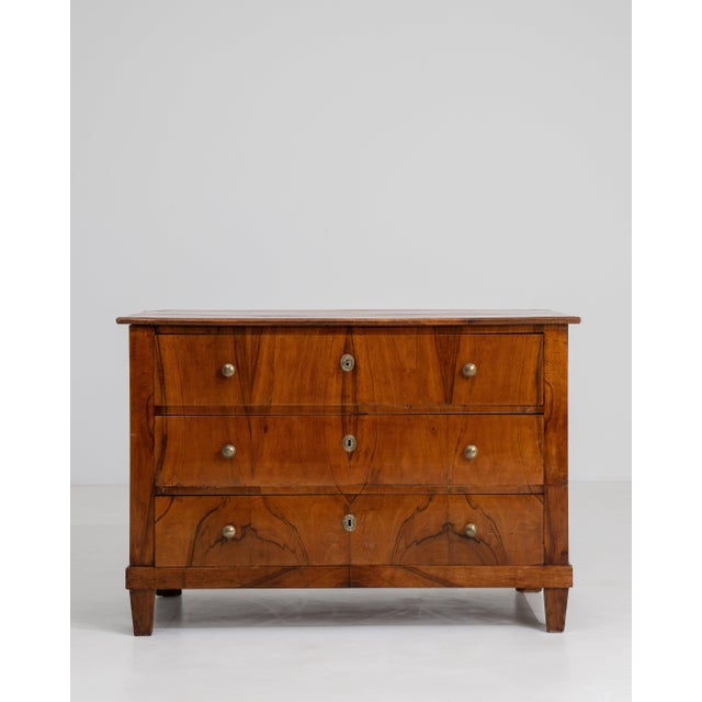 A refined example of Biedermeier craftsmanship, this 19th-century French chest of drawers embodies the movement's...
