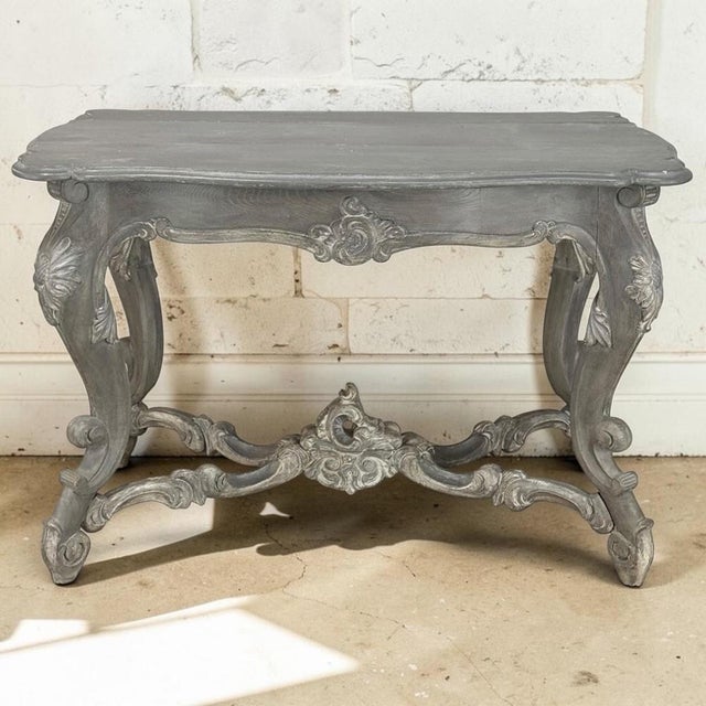 This 19th century French center table is a finely executed interpretation of the Régence style, distinguished by its...