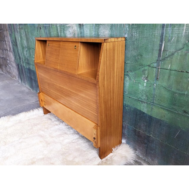 Very versatile Twin headboard featuring a bookcase with sliding doors, and three holes ideal for cables, meant to house...