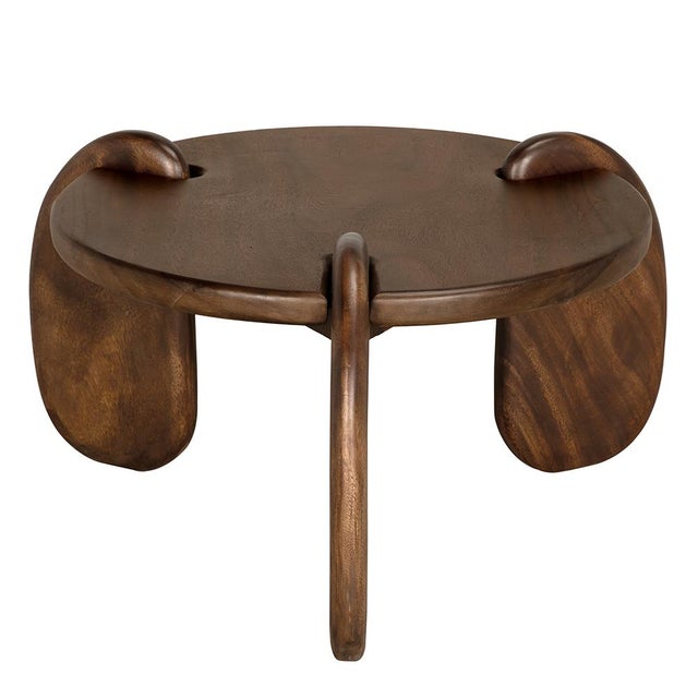 This sculptural teak coffee table features a rich finish and playful, oversized looped legs that extend through the top...