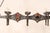 A vintage French six-light chandelier. This French chandelier from the mid 20th century of forged iron has a slender...