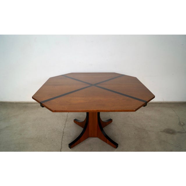 Original vintage Midcentury Modern dining table for sale. It's made of walnut with a black x design on the top, and has...