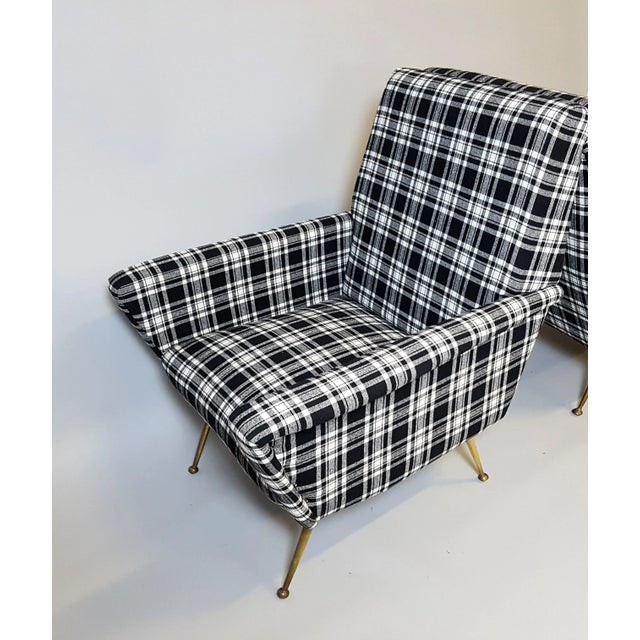 This Italian armchair was designed in a style reminiscent of Marco Zanuso's Lady Chair. It features brass feet and has...