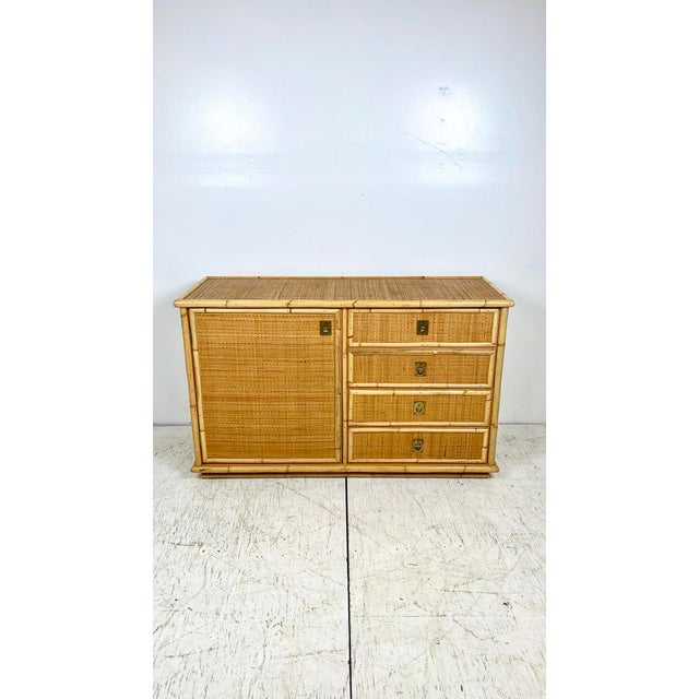 Vintage rattan sideboard credenza. Made in 1977 by Italian furniture company Dal Vera. Thick rattan/bamboo trim with woven...