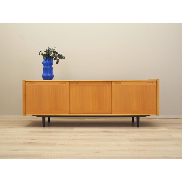 The sideboard was made in the 1970s, produced by the well-known Danish manufactory Skovby Møbelfabrik. The structure is...