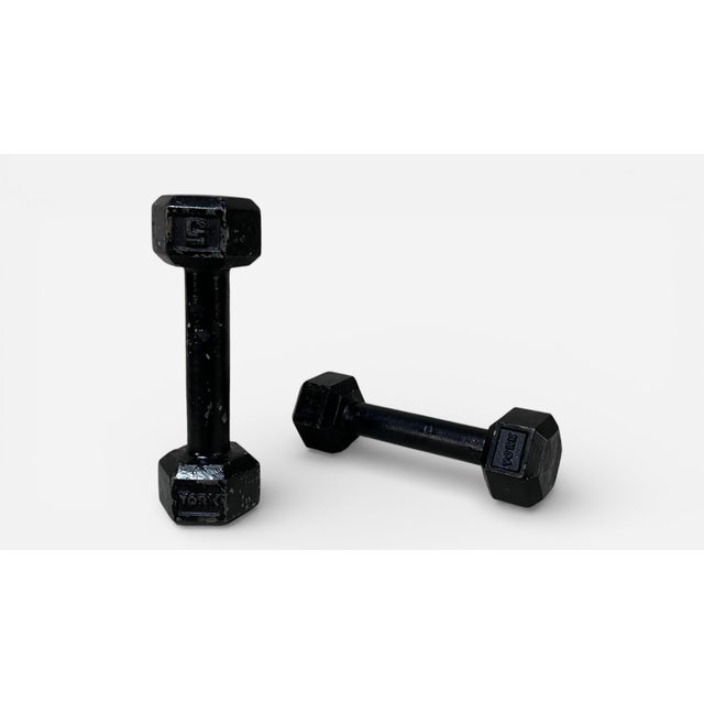 Vintage set of 5lb dumbbells by York. Iron with enamel painted coating. To be used as artistic objects or bookends.