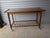 Wonderful rolling cart in what appears to be walnut, with integrated handles, delicate bottom spindle shelf, tapered legs...