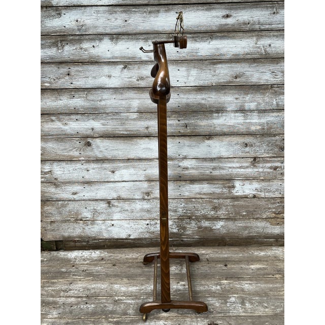 Vintage Italian folding valet in a polished walnut finish with brass hardware, casters, coin/jewelry tray and pants...