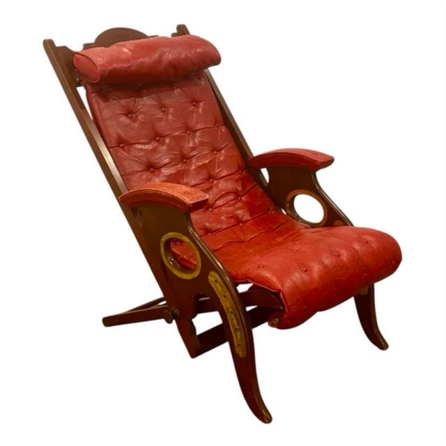 Circa 1890 English campaign armchair with a reclining solid mahogany and brass frame, upholstered in Moroccan red leather...