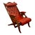 Circa 1890 English campaign armchair with a reclining solid mahogany and brass frame, upholstered in Moroccan red leather...