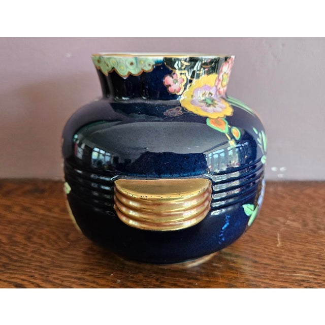 Art Deco Vase with a floral enamelled design by Crown Devon. Bulbous shape with ribbing through the centre leading to...