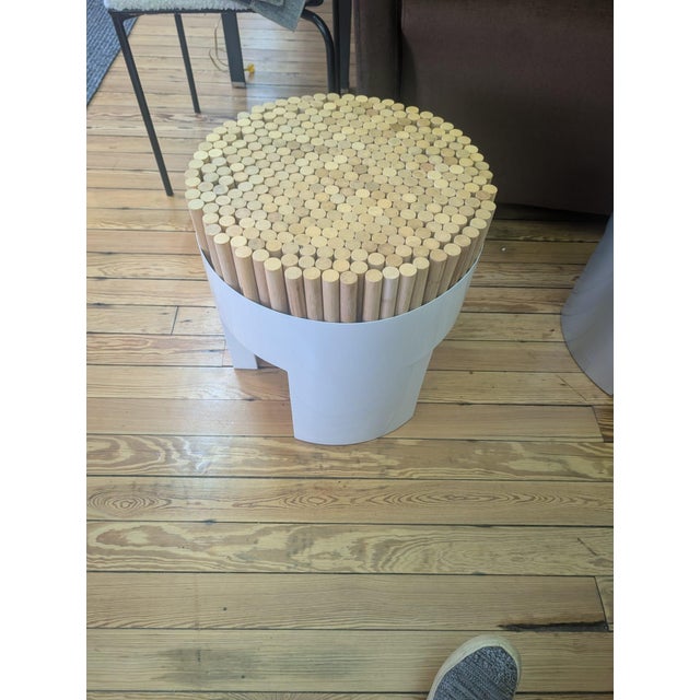 Kenneth Cobonpue Chiquita stool featuring a sculptural cylindrical silhouette with a natural wood top and a clean white...