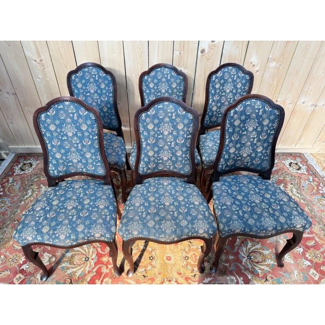 Set of six English Chippendale-style chairs in dark brown stained mahogany, 19th century. The structure displays typical...