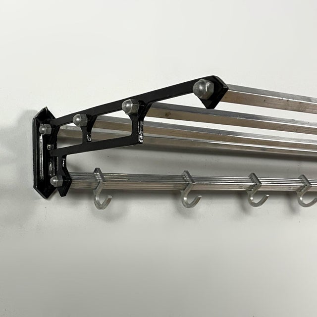 Vintage aluminum coat rack from the 1950s, featuring a distinctive industrial design. The lightweight yet sturdy frame is...