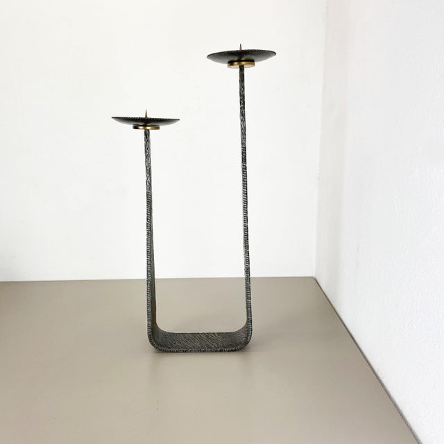This original vintage candleholder, was produced in the 1970s in Germany. it is made of solid heavy metal, and has a...