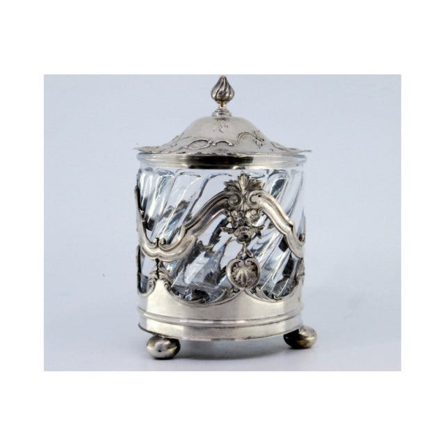 Silver Bonbon Box with a Cut Glass Core and Relief with Flowers and Plant Motifs and Supported by Three Round Feet., in...