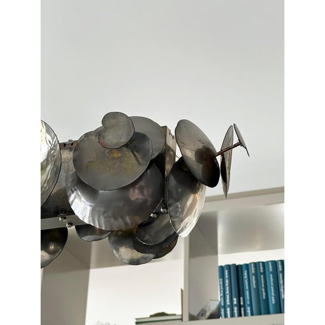 This linear chandelier, known as the Eucalyptus Chandelier by Ochre London and created in 2011, is a sculptural linear...