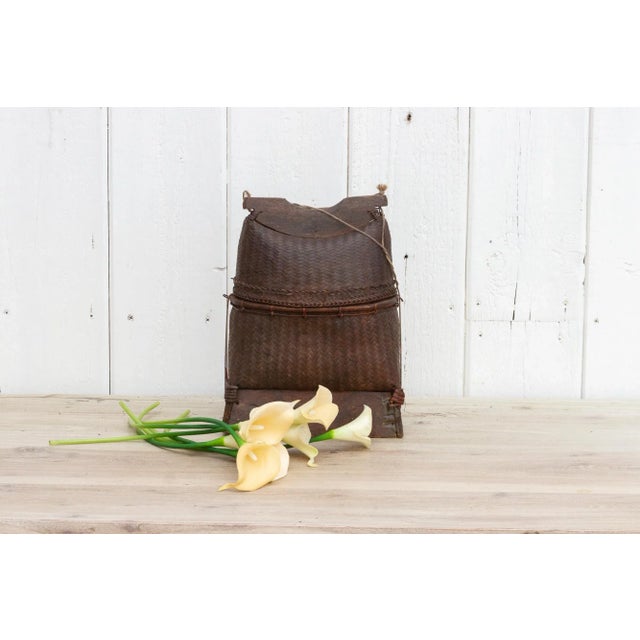 A charming mid-century finely woven basket with lid from Thailand. This vintage basket was originally was used to store...