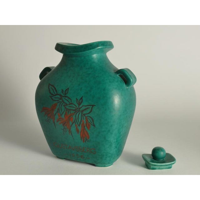 This rare and highly decorative lidded vase is a striking example of mid-century Scandinavian ceramic artistry, designed...