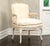 A pair of early 20th century Louis XV style painted bergère armchairs featuring carved hardwood frames, cabriole legs,...