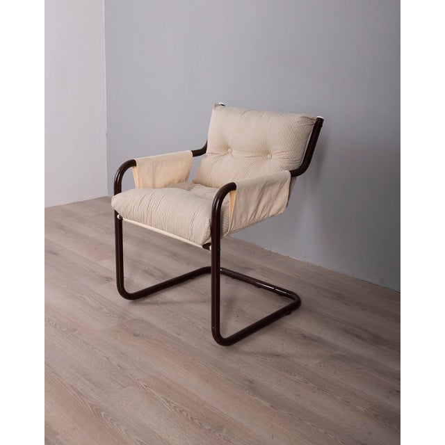 Brown tubular metal armchair with striped fabric upholstery, Scandinavian design, 1970s.