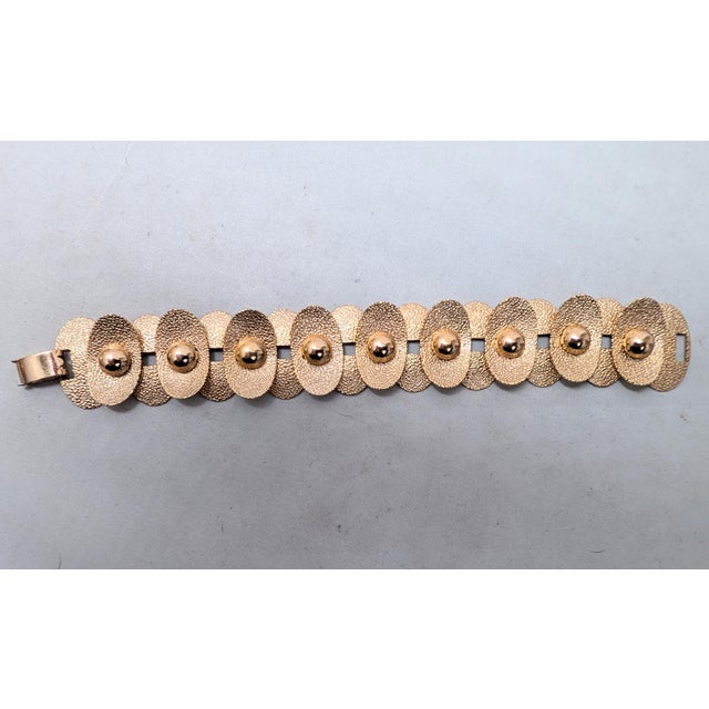 1960s Modernist textured goldtone oval convex and concave links with smooth domed circles on the concave links articulated...