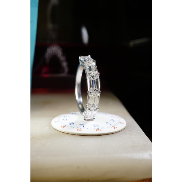 Diamond Eternity Band set in Platinum. 5 Emerald cut natural diamonds are DEF-VVS2-VS2. All stones are GIA certified and...