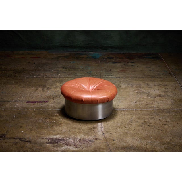 Francois Monnet Round Ottoman with bright orange leather tufted top and brushed metal base offers a distinctive modern...