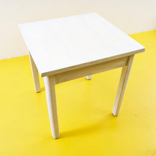 This charming white wooden table combines elegance and functionality, perfect for any setting. Its simple lines and rustic...