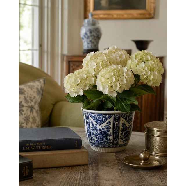 A handsome mid-20th-century ceramic cachepot by Royal Boch, decorated in deep cobalt blue against a crisp white ground....