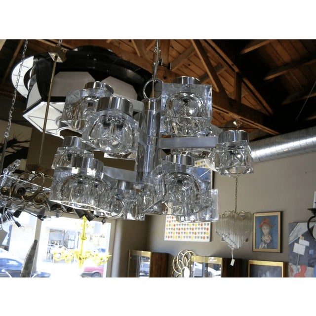A Gaetano Sciolari designed 12 light chandelier, made for Lightolier, in three levels of four arms and cubes. Lower and...