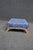 Louis XV style ottoman featuring a carved and painted wood frame with graceful scroll feet and decorative apron detailing....