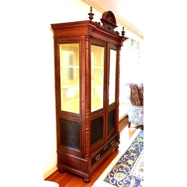 A late 19th-century Belgian Aesthetic Movement display vitrine, circa 1875–1890, distinguished by elaborate faux-grain...