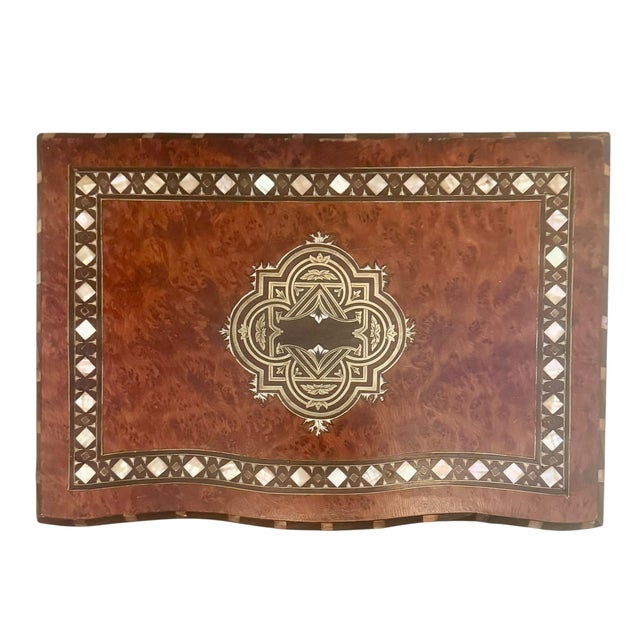 A handsome French Napoleon III walnut box, richly decorated with intricate mother-of-pearl, ivory and brass inlay. The...