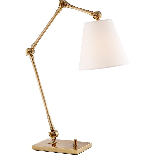Graves Task Lamp in Hand-Rubbed Antique Brass with Linen Shade Designer: Suzanne Kasler Height: 18.25" - 28.75" Shade...
