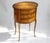 An amazing large oval French Louis XV style nightstand with three drawers. The wooden table has beautiful floral inlaid...