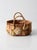 This vintage handmade basket features woven natural fibers with floral raffia detailing and braided handles in softly...