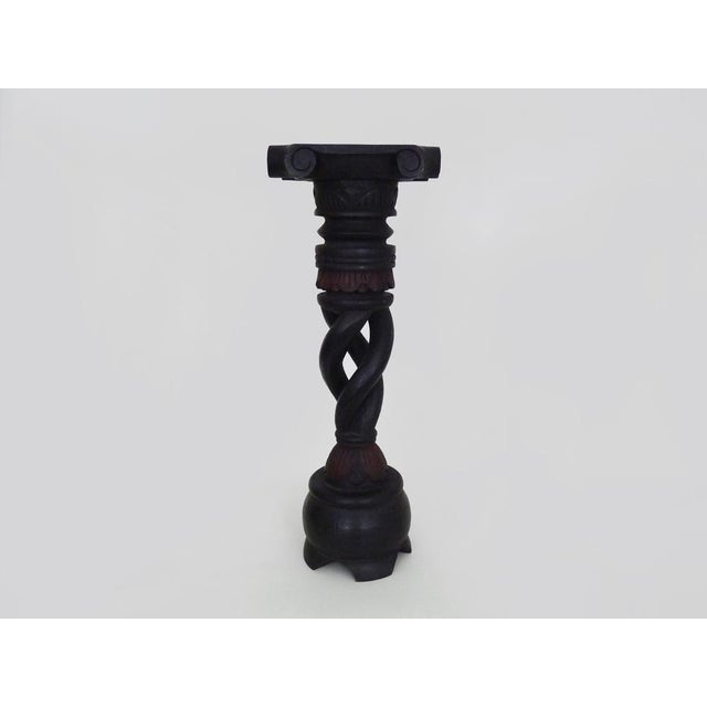 Carved, twisted, and engraved blackened wood plant stand. 1960s-70s Finely carved and twisted wood plant stand with...